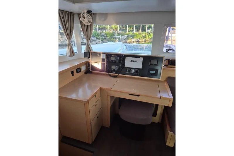 Chapter Two Yacht Photos Pics Interior view of 2014 Lagoon 450 yacht's navigation station with equipment and seating.