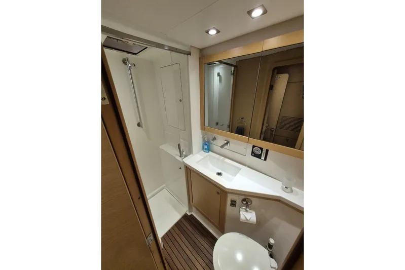 Chapter Two Yacht Photos Pics Luxurious bathroom in 2014 Lagoon 450 yacht with modern fixtures and wooden flooring.