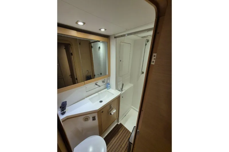 Chapter Two Yacht Photos Pics Bathroom interior of 2014 Lagoon 450 yacht, featuring modern fixtures and wooden accents.
