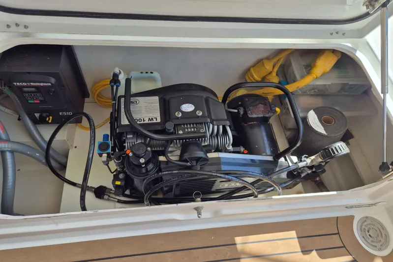 Chapter Two Yacht Photos Pics Engine compartment of a 2014 Lagoon 450 catamaran, featuring mechanical components and wiring.