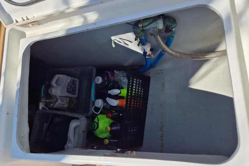 Chapter Two Yacht Photos Pics Storage compartment on a 2014 Lagoon 450 yacht with cleaning supplies and equipment.