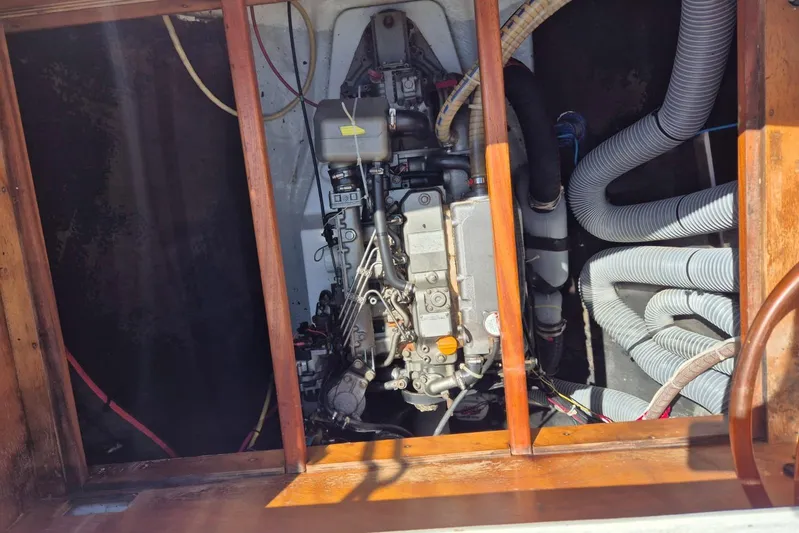 Chapter Two Yacht Photos Pics Engine compartment of a 2014 Lagoon 450 catamaran, showing mechanical components and hoses.