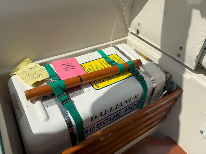 Dalliance Yacht Photos Pics Rescue pod on 1993 Pacific Seacraft Crealock 34, secured with green straps and wooden handle.