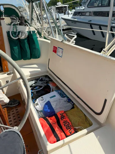 Dalliance Yacht Photos Pics Open storage compartment on 1993 Pacific Seacraft Crealock 34 sailboat, filled with boating gear.