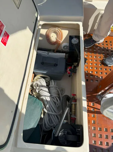 Dalliance Yacht Photos Pics Storage compartment on a 1993 Pacific Seacraft Crealock 34 sailboat, containing ropes and equipment.
