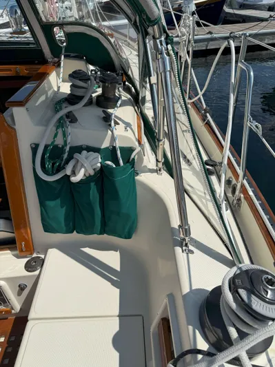 Dalliance Yacht Photos Pics 1993 Pacific Seacraft Crealock 34 sailboat deck with green storage bags and winches.