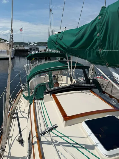 Dalliance Yacht Photos Pics Sailboat docked at marina, Pacific Seacraft Crealock 34, 1993 model, with green canvas covers.