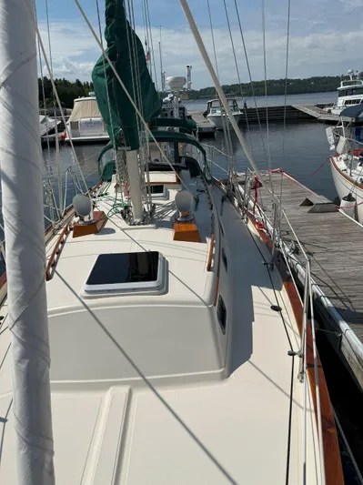 Dalliance Yacht Photos Pics Sailboat docked at marina, Pacific Seacraft Crealock 34, 1993 model, with green sail cover.