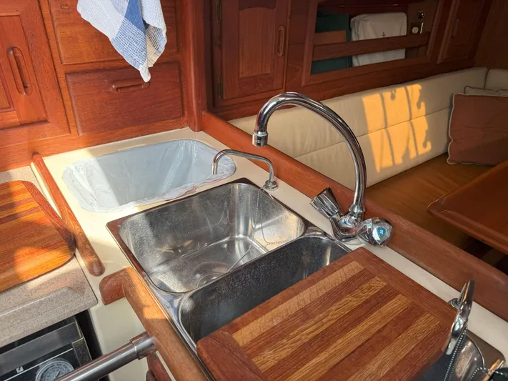 Dalliance Yacht Photos Pics Galley of 1993 Pacific Seacraft Crealock 34 with stainless steel sink and wooden accents.