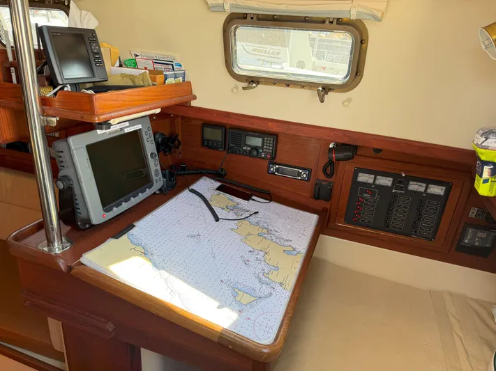 Dalliance Yacht Photos Pics Navigation station on 1993 Pacific Seacraft Crealock 34 sailboat with chart and electronics.