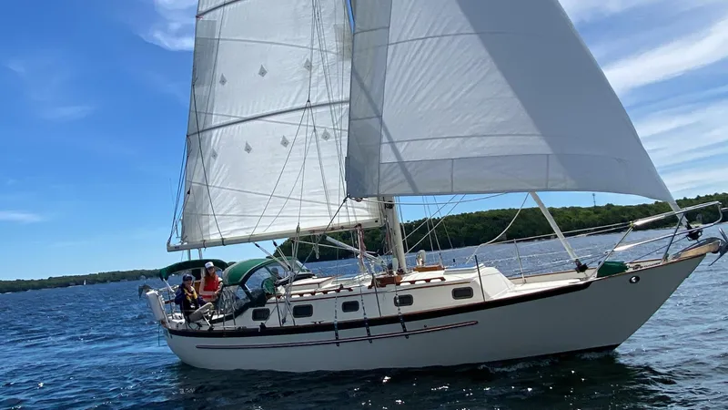 Dalliance Yacht Photos Pics Sailboat Pacific Seacraft Crealock 34, 1993 model, sailing on a sunny day.