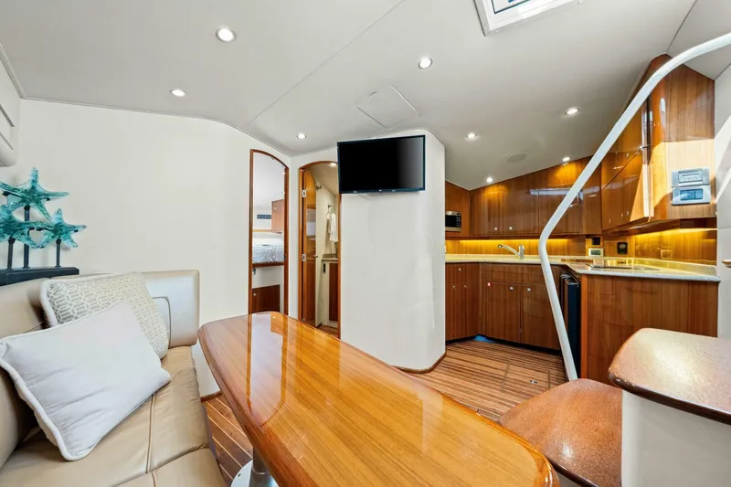 Bad Habit Yacht Photos Pics Luxurious interior of 2012 Viking 42 Open yacht with modern kitchen and seating area.
