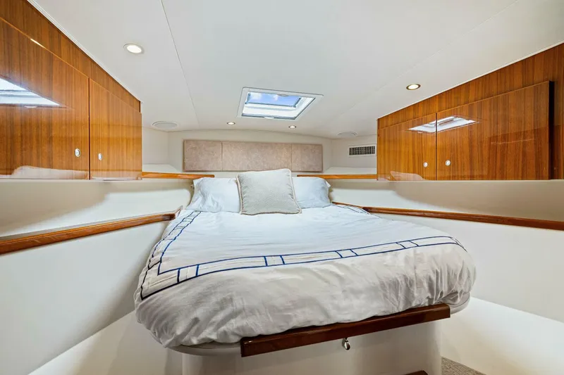 Bad Habit Yacht Photos Pics Luxurious cabin interior of 2012 Viking 42 Open yacht with wood paneling and skylight.