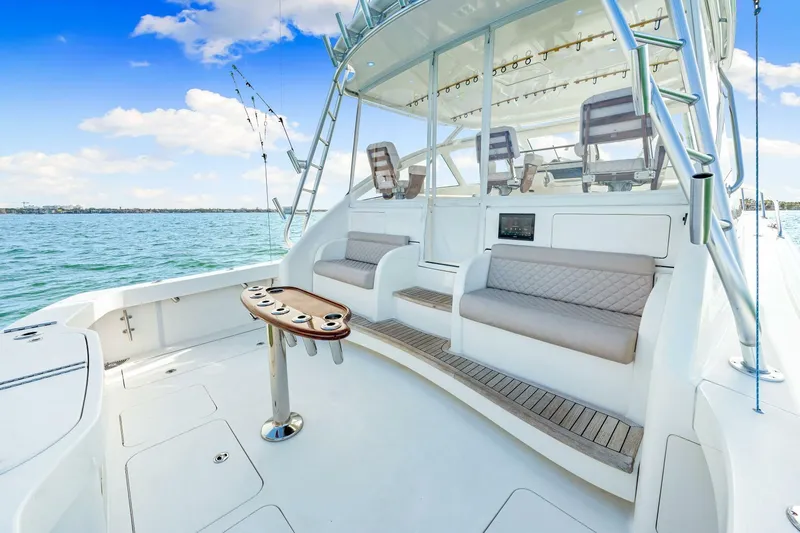 Bad Habit Yacht Photos Pics 2012 Viking 42 Open yacht with spacious deck and seating, under a clear blue sky.