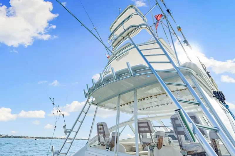 Bad Habit Yacht Photos Pics 2012 Viking 42 Open yacht with fishing rods, ladder, and clear blue sky.