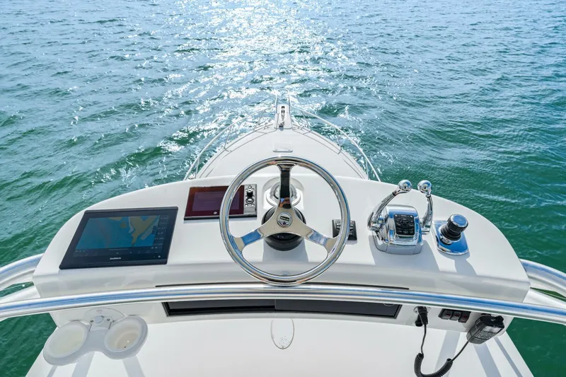 Bad Habit Yacht Photos Pics Helm of 2012 Viking 42 Open yacht with navigational equipment on open water.