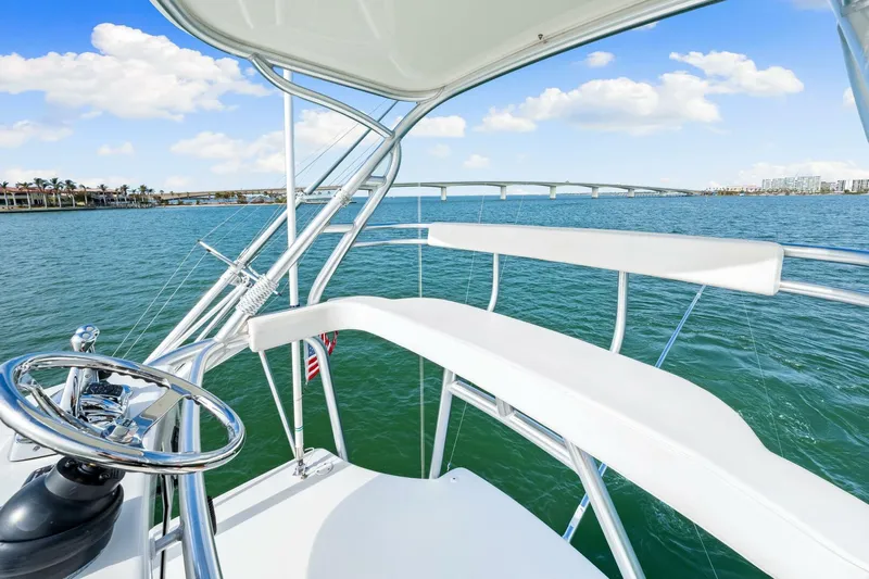 Bad Habit Yacht Photos Pics 2012 Viking 42 Open yacht helm with ocean view and bridge in background.