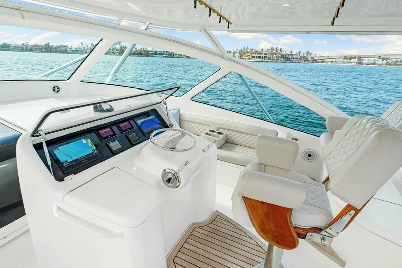 Bad Habit Yacht Photos Pics Luxurious 2012 Viking 42 Open yacht helm with modern navigation system and plush seating.
