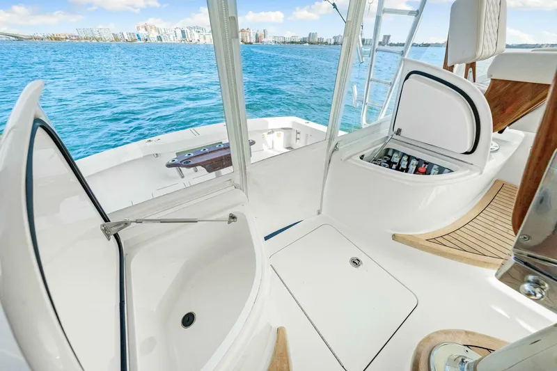 Bad Habit Yacht Photos Pics 2012 Viking 42 Open yacht deck with storage compartments, overlooking ocean and city skyline.