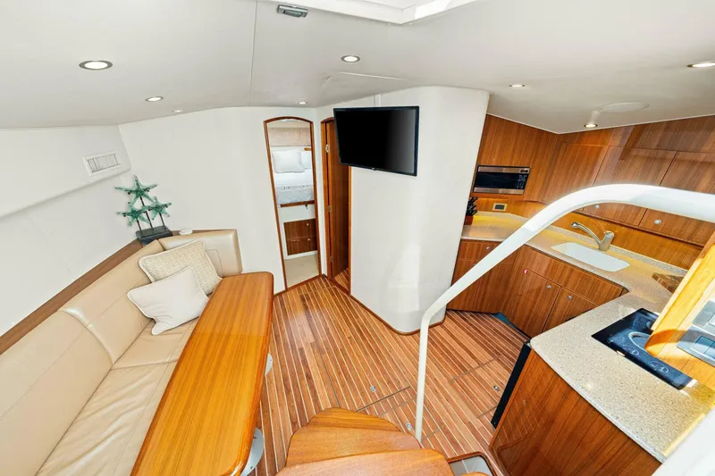 Bad Habit Yacht Photos Pics Luxurious interior of 2012 Viking 42 Open yacht with modern kitchen and seating area.