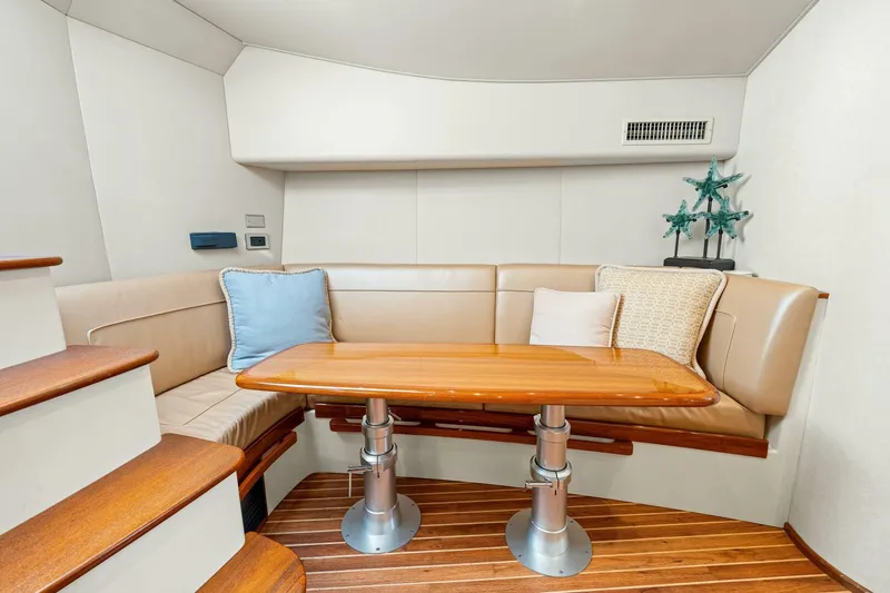 Bad Habit Yacht Photos Pics Luxurious interior of 2012 Viking 42 Open yacht with elegant seating and wooden table.