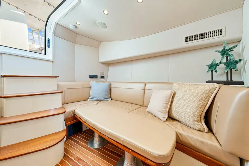 Bad Habit Yacht Photos Pics Luxurious interior of 2012 Viking 42 Open yacht with plush seating and elegant decor.