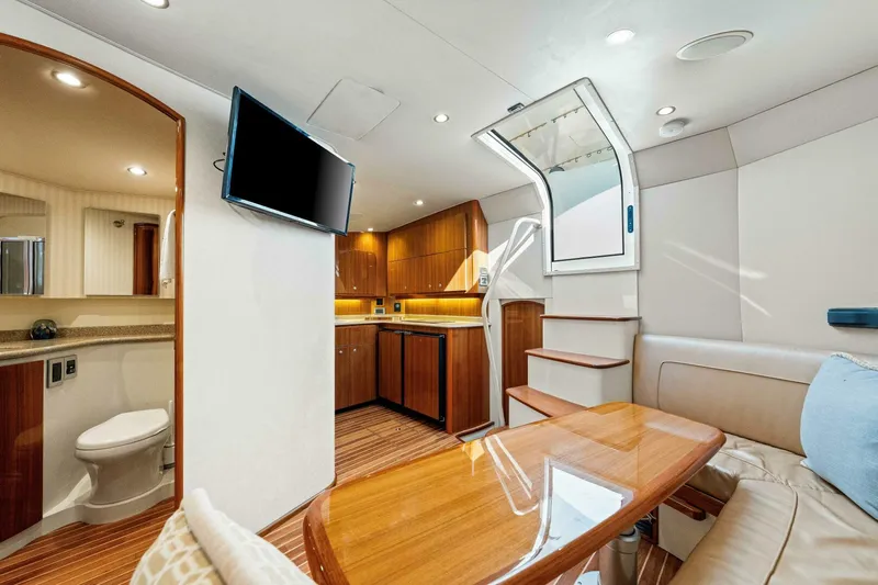 Bad Habit Yacht Photos Pics Luxurious interior of 2012 Viking 42 Open yacht with modern kitchen and seating area.