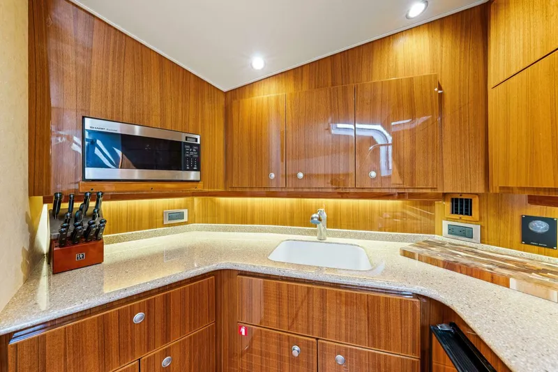 Bad Habit Yacht Photos Pics Luxurious kitchen in 2012 Viking 42 Open yacht with wood cabinetry and modern appliances.