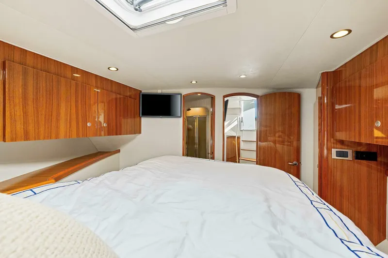 Bad Habit Yacht Photos Pics Luxurious cabin interior of 2012 Viking 42 Open yacht with wood finishes and modern amenities.