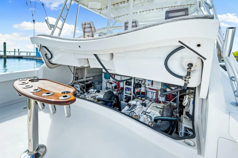 Bad Habit Yacht Photos Pics Engine compartment of 2012 Viking 42 Open yacht with fishing rod holders.