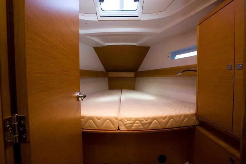 Urkab Yacht Photos Pics Manufacturer Provided Image: 2018 Jeanneau Sun Odyssey 449 cabin interior with bed and wooden cabinetry.
