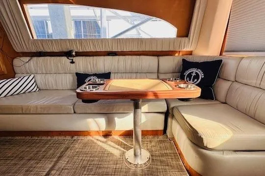 Lolita Yacht Photos Pics Interior of 2001 Luhrs 40 Convertible yacht with cozy seating and nautical decor.