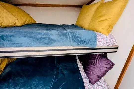 Lolita Yacht Photos Pics Bunk beds with colorful bedding in a 2001 Luhrs 40 Convertible boat cabin.