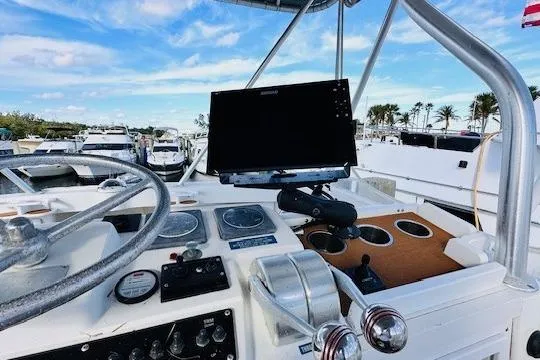 Lolita Yacht Photos Pics 2001 Luhrs 40 Convertible boat helm with steering wheel and navigation equipment.