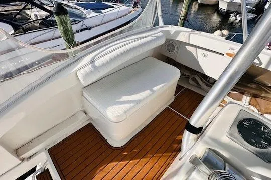 Lolita Yacht Photos Pics 2001 Luhrs 40 Convertible boat interior with cushioned seating and wooden deck.