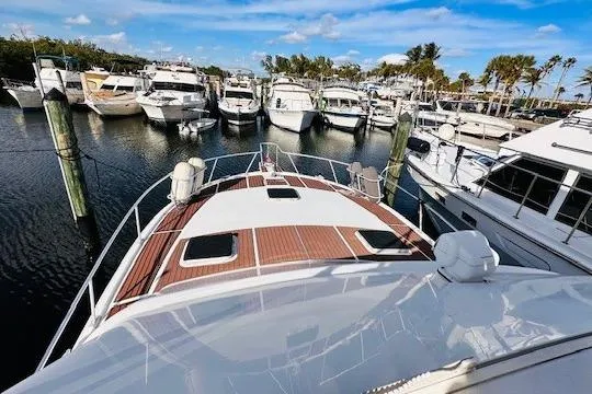 Lolita Yacht Photos Pics 2001 Luhrs 40 Convertible yacht docked in a marina, surrounded by other boats.