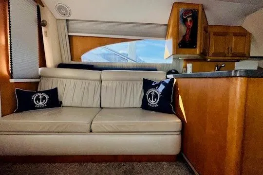 Lolita Yacht Photos Pics Interior of 2001 Luhrs 40 Convertible yacht with cream sofa and nautical-themed pillows.