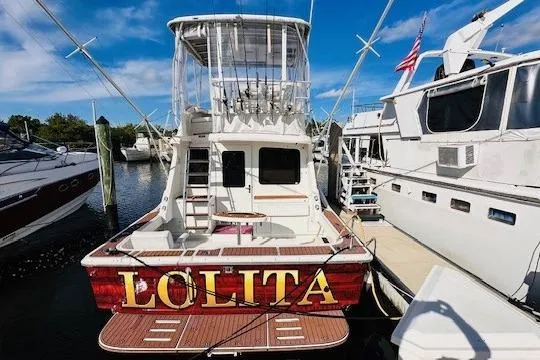 Lolita Yacht Photos Pics 2001 Luhrs 40 Convertible boat named "Lolita" docked at a marina.