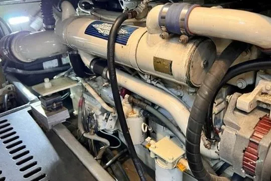 Lolita Yacht Photos Pics Engine compartment of a 2001 Luhrs 40 Convertible boat, showcasing mechanical components.