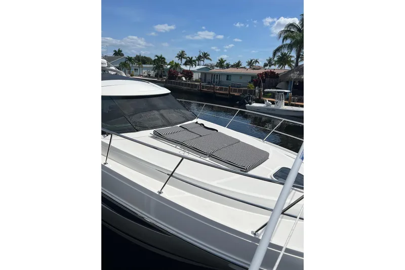  Yacht Photos Pics 2014 Sea Ray 410 Sundancer yacht docked, featuring sleek design and striped sun pads.