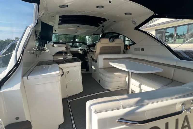  Yacht Photos Pics Luxurious interior of 2014 Sea Ray 410 Sundancer yacht with seating and table.