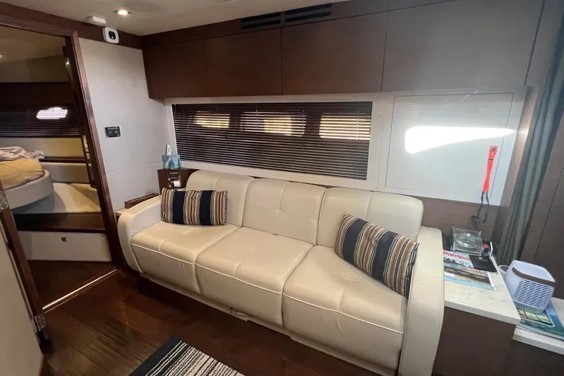  Yacht Photos Pics Interior of 2014 Sea Ray 410 Sundancer yacht with cream sofa and striped pillows.