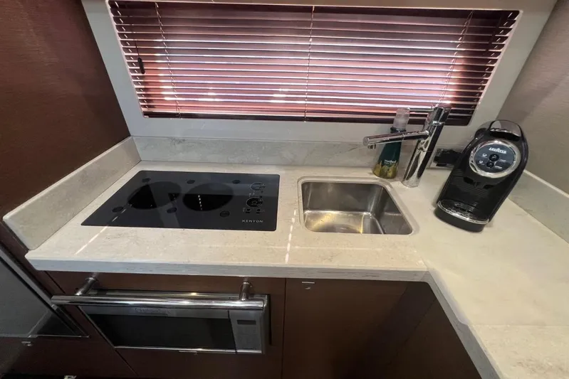  Yacht Photos Pics 2014 Sea Ray 410 Sundancer kitchen with stove, sink, and coffee maker.