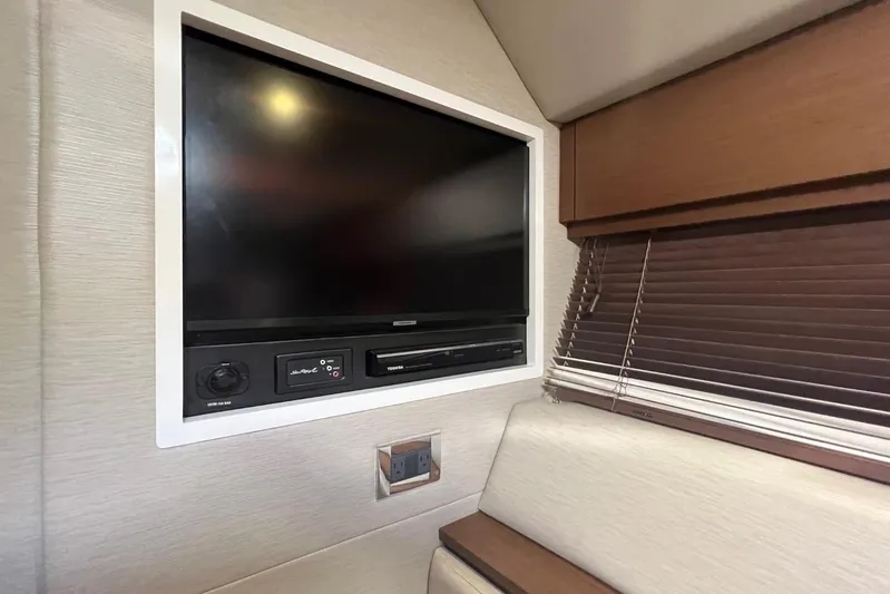  Yacht Photos Pics Entertainment system in 2014 Sea Ray 410 Sundancer yacht interior with TV and controls.