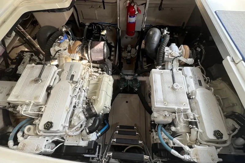  Yacht Photos Pics Engine room of a 2014 Sea Ray 410 Sundancer, featuring dual engines and a fire extinguisher.