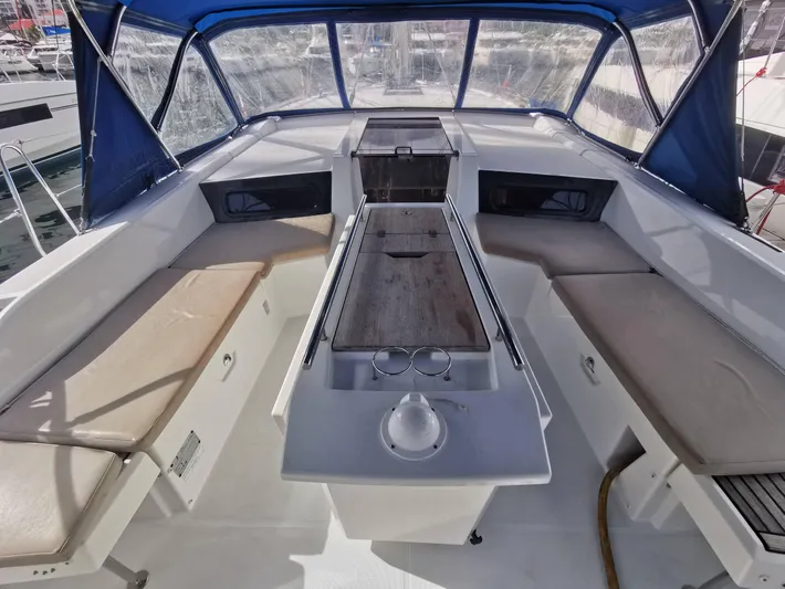 Siman H Yacht Photos Pics Interior view of 2020 Beneteau Oceanis 46.1 sailboat cockpit with seating and table.