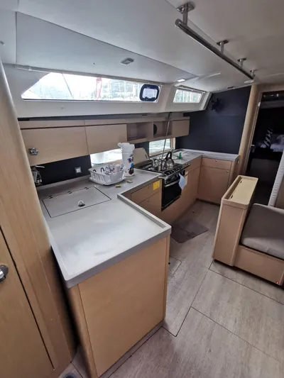 Siman H Yacht Photos Pics Interior of 2020 Beneteau Oceanis 46.1 yacht, featuring modern kitchen and seating area.