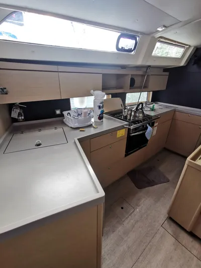 Siman H Yacht Photos Pics Modern kitchen in 2020 Beneteau Oceanis 46.1 yacht with sleek cabinetry and appliances.