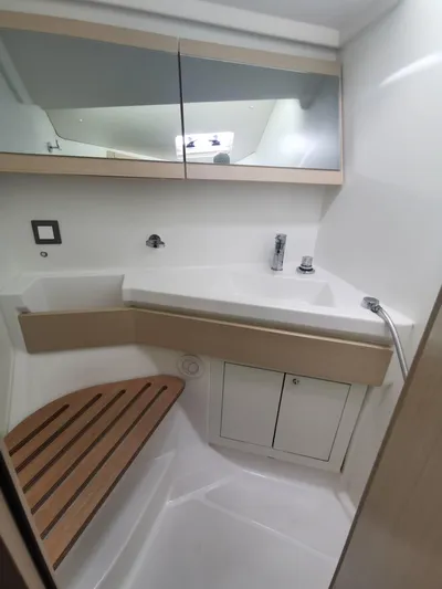 Siman H Yacht Photos Pics Modern bathroom in 2020 Beneteau Oceanis 46.1 yacht with sleek fixtures and wooden accents.