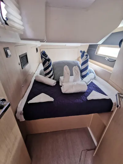 Siman H Yacht Photos Pics Cozy cabin interior of 2020 Beneteau Oceanis 46.1 yacht with neatly arranged bedding.
